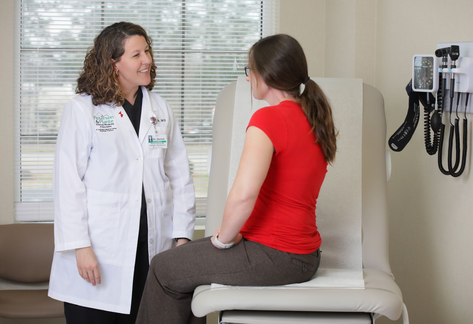 Doctor speaking to a patient in an exam room.