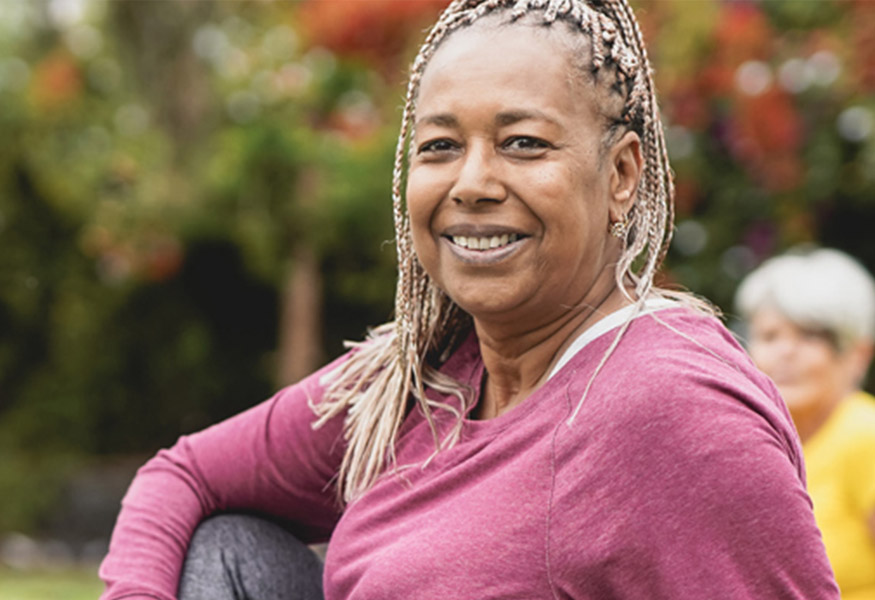 A smiling woman wearing exercise clothes.